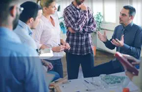 Team discussing around a table in office.