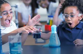 Children excitedly conducting a science experiment.