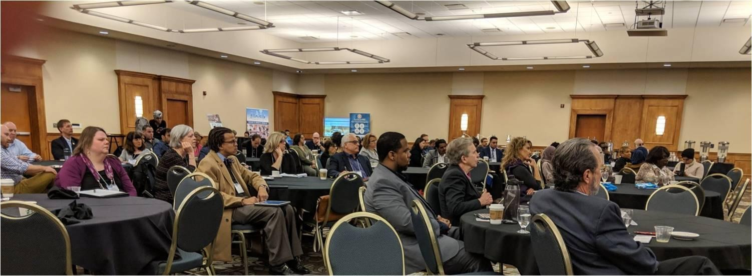 Conference attendees seated at round tables